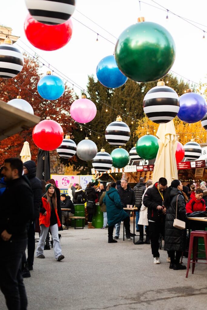 Vibrant scene of a Christmas market in Zagreb with colorful decorations and bustling crowd.